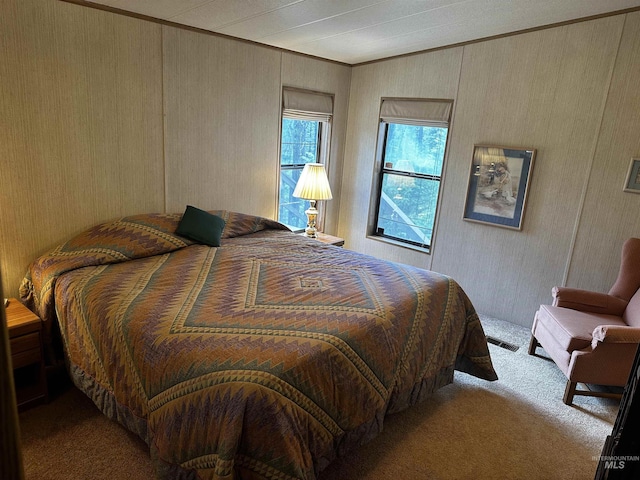 carpeted bedroom featuring crown molding