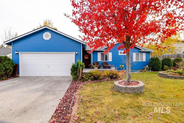 single story home featuring a garage and a front lawn