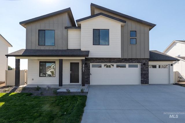 2853 N Eagle Meadow Ave, Kuna, ID 83634 - view of front of house featuring a garage, a front yard, and a porch
