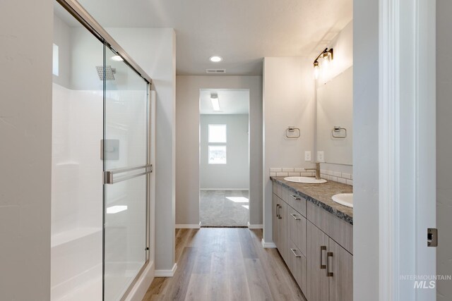 2853 N Eagle Meadow Ave, Kuna, ID 83634 - bathroom featuring walk in shower, wood-type flooring, and vanity