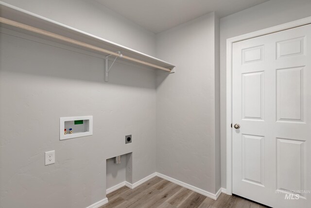 2853 N Eagle Meadow Ave, Kuna, ID 83634 - laundry room with electric dryer hookup, hookup for a washing machine, and light hardwood / wood-style floors