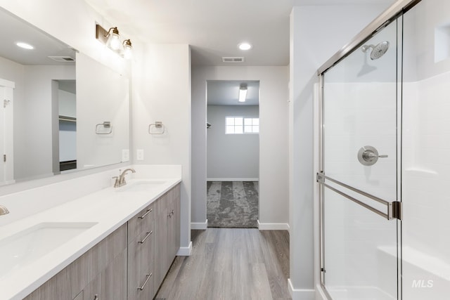 2853 N Eagle Meadow Ave, Kuna, ID 83634 - bathroom featuring a shower with door, wood-type flooring, and vanity
