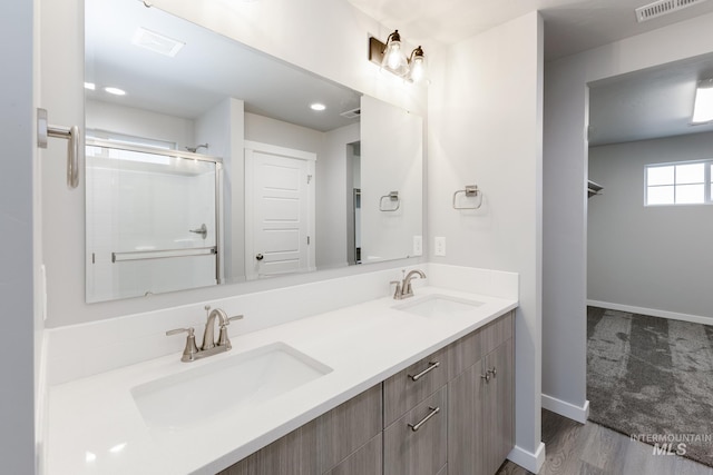 2853 N Eagle Meadow Ave, Kuna, ID 83634 - bathroom featuring vanity, hardwood / wood-style flooring, and a shower with shower door