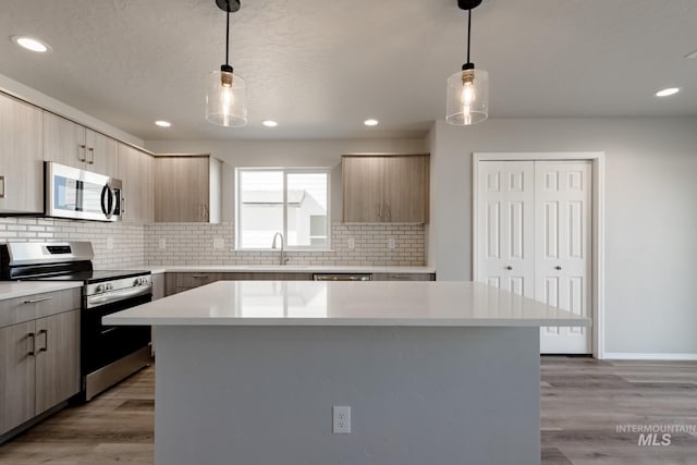2853 N Eagle Meadow Ave, Kuna, ID 83634 - kitchen with appliances with stainless steel finishes, a center island, and hanging light fixtures