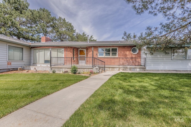 2371 SW 2nd Ave, Ontario, OR 97914 - ranch-style home featuring brick siding, a chimney, and a front yard