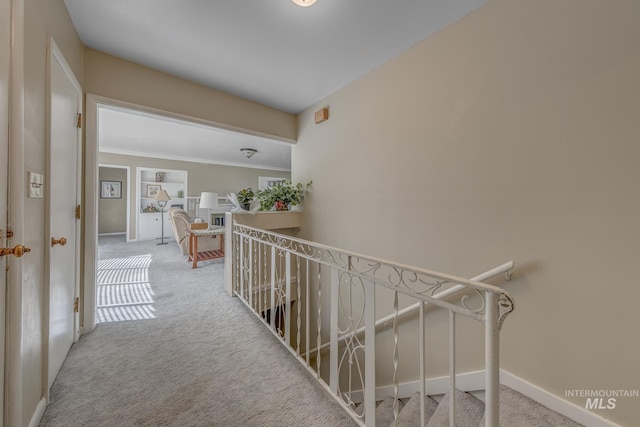 2371 SW 2nd Ave, Ontario, OR 97914 - hallway featuring carpet flooring, an upstairs landing, baseboards, and crown molding