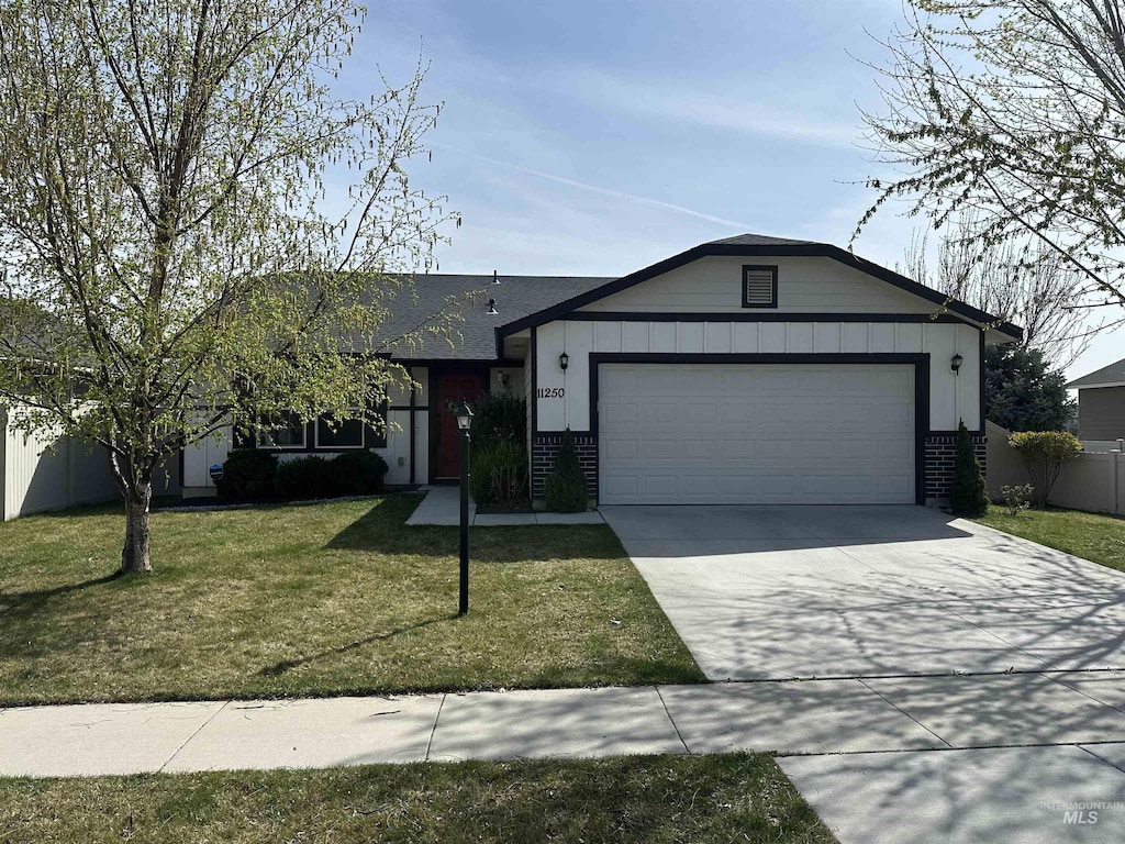11250 W Bodie River Loop, Nampa, ID 83686 - ranch-style home featuring concrete driveway, a front yard, brick siding, a garage, and fence