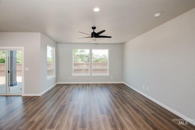 unfurnished living room with ceiling fan, recessed lighting, baseboards, and dark wood finished floors