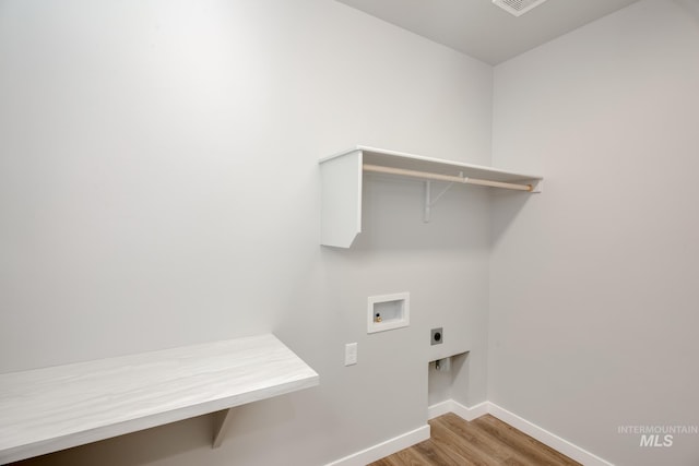 laundry area with wood finished floors, laundry area, hookup for an electric dryer, baseboards, and hookup for a washing machine