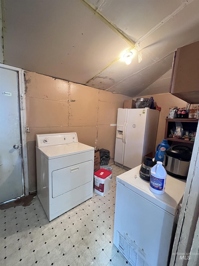 clothes washing area featuring light floors and cabinet space