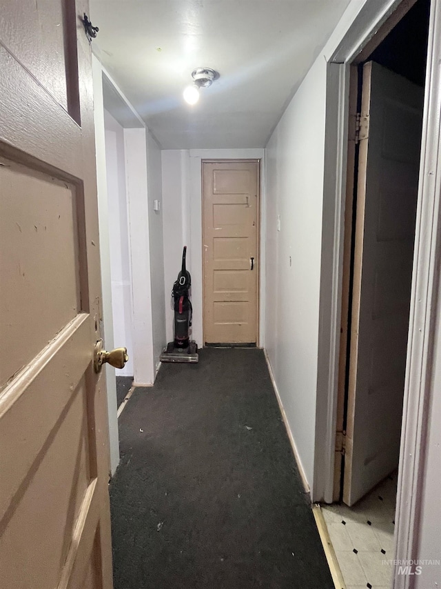 hallway with baseboards and carpet flooring