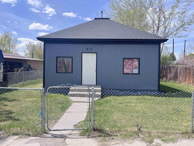 bungalow-style house featuring roof with shingles, a gate, a front yard, and fence private yard