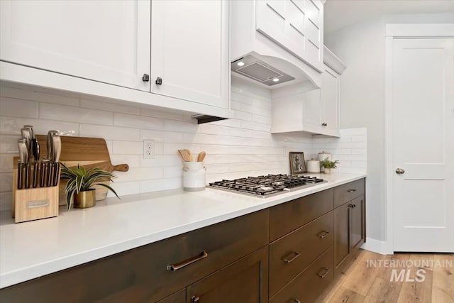 4153 E Raincloud Ln, Boise, ID 83716 - kitchen featuring stainless steel gas stovetop, light countertops, white cabinetry, and light wood-style flooring