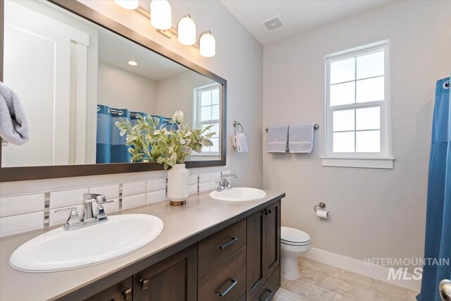 4153 E Raincloud Ln, Boise, ID 83716 - full bathroom with double vanity and a shower with curtain