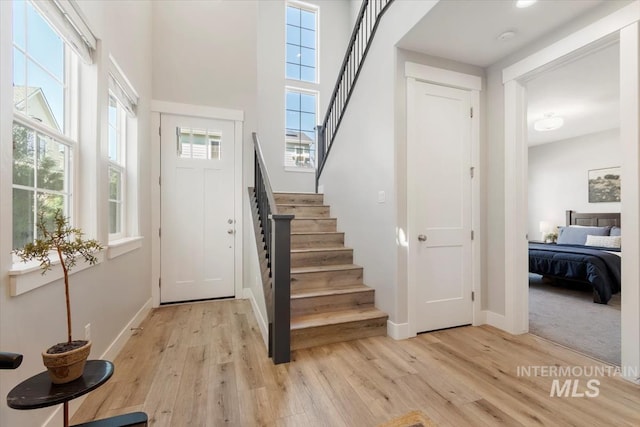 4153 E Raincloud Ln, Boise, ID 83716 - foyer with light wood-style flooring, stairway, plenty of natural light, and a towering ceiling