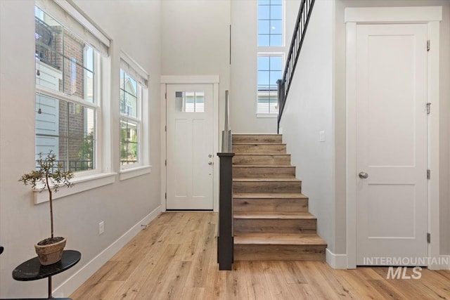 4153 E Raincloud Ln, Boise, ID 83716 - entryway featuring stairway, light wood finished floors, and a high ceiling