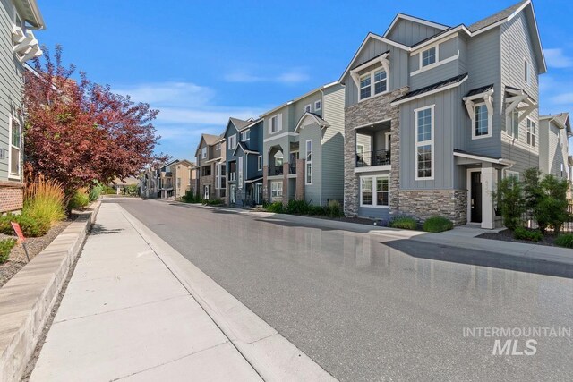 4153 E Raincloud Ln, Boise, ID 83716 - view of asphalt road featuring a residential view, sidewalks, and curbs