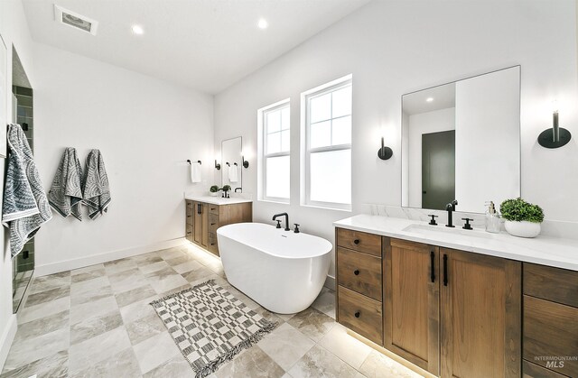 3496 W Parodin St, Eagle, ID 83616 - full bath with a freestanding tub, two vanities, recessed lighting, and baseboards