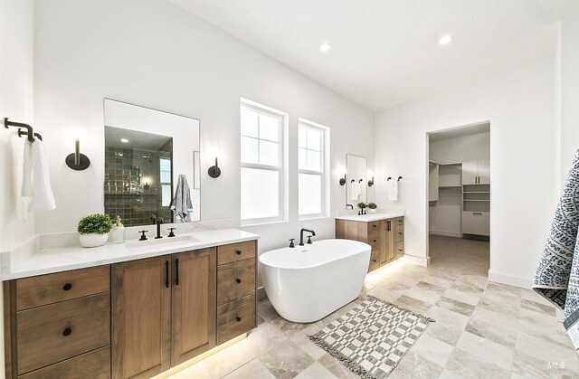 3496 W Parodin St, Eagle, ID 83616 - bathroom with a stall shower, two vanities, a freestanding tub, recessed lighting, and a spacious closet