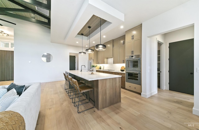 3496 W Parodin St, Eagle, ID 83616 - kitchen featuring stainless steel appliances, light countertops, a breakfast bar area, light wood finished floors, and baseboards