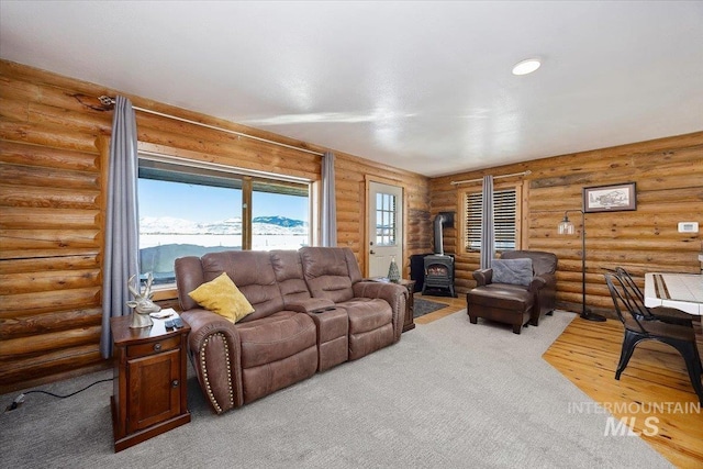 living room featuring hardwood / wood-style floors, a mountain view, and a wood stove