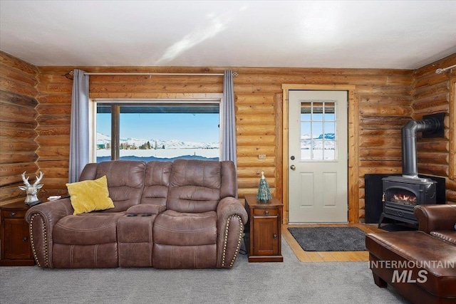 living room with rustic walls and a wood stove