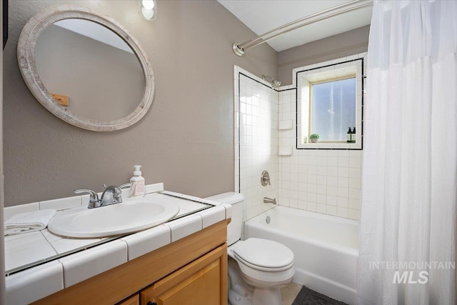 full bathroom with shower / bath combo, vanity, and toilet