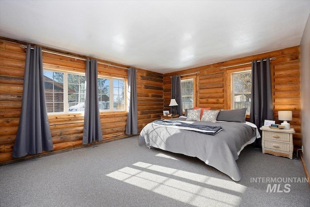 carpeted bedroom featuring multiple windows