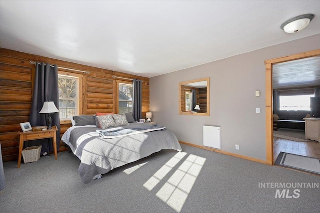 bedroom featuring carpet floors and rustic walls