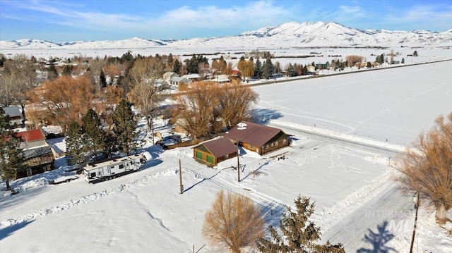 snowy aerial view featuring a mountain view