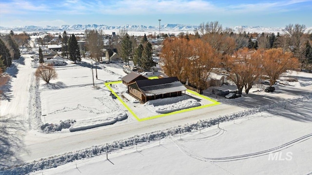 snowy aerial view featuring a mountain view