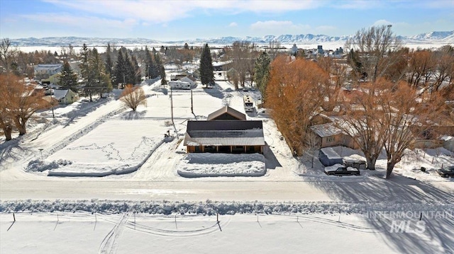 snowy aerial view featuring a mountain view