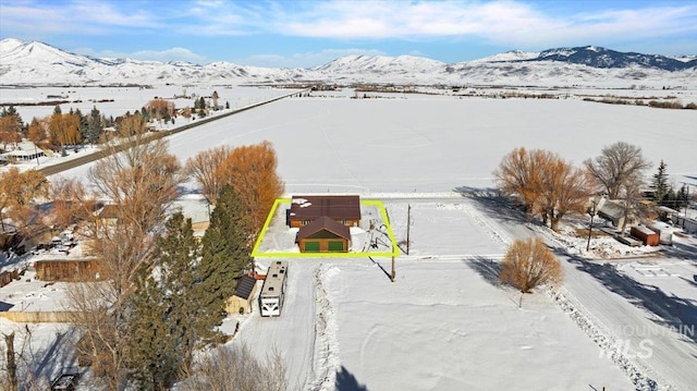 snowy aerial view with a mountain view