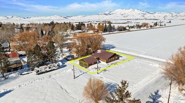 snowy aerial view with a mountain view