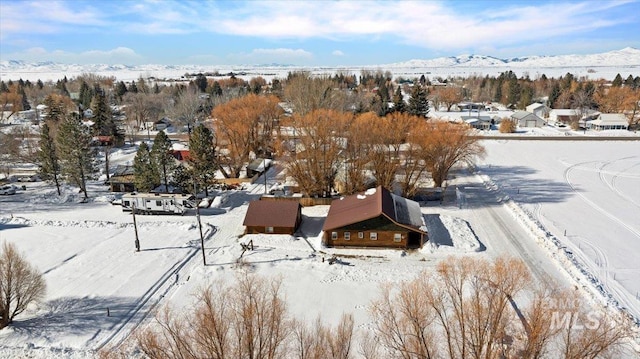 snowy aerial view with a mountain view