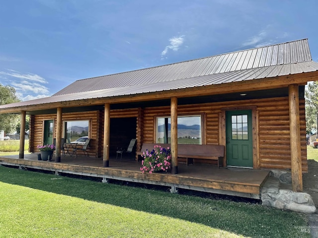 rear view of property featuring a yard