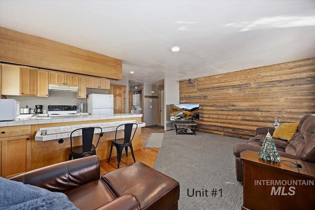 living room featuring log walls and light hardwood / wood-style flooring