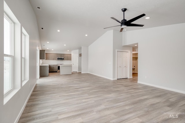 unfurnished living room featuring baseboards and recessed lighting