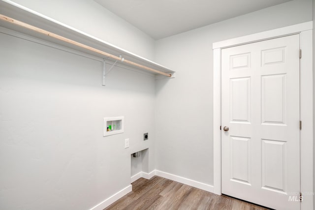washroom featuring baseboards, washer hookup, wood finished floors, hookup for an electric dryer, and laundry area