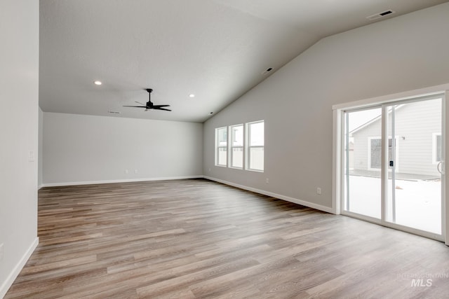 unfurnished living room featuring ceiling fan, lofted ceiling, baseboards, and light wood finished floors