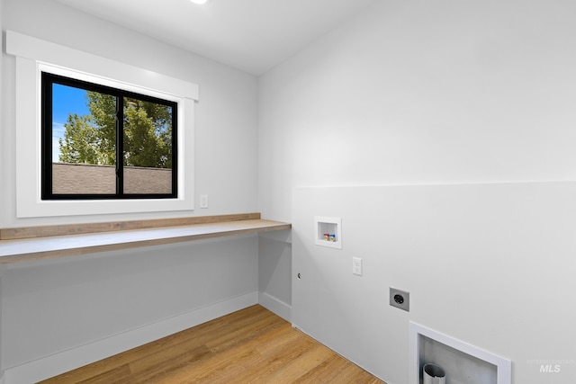 clothes washing area with washer hookup, electric dryer hookup, light wood-type flooring, and hookup for a gas dryer