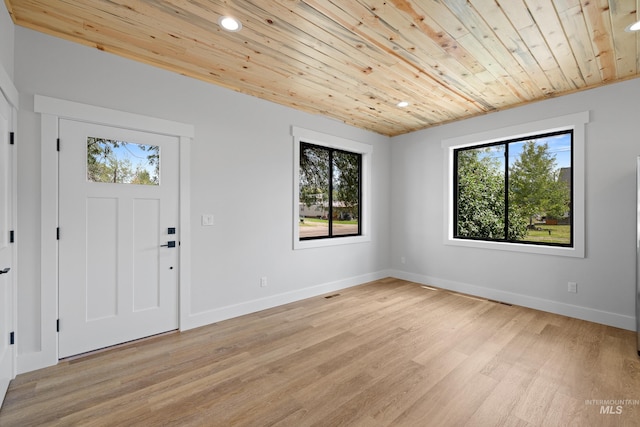 foyer with light wood-type flooring and wooden ceiling