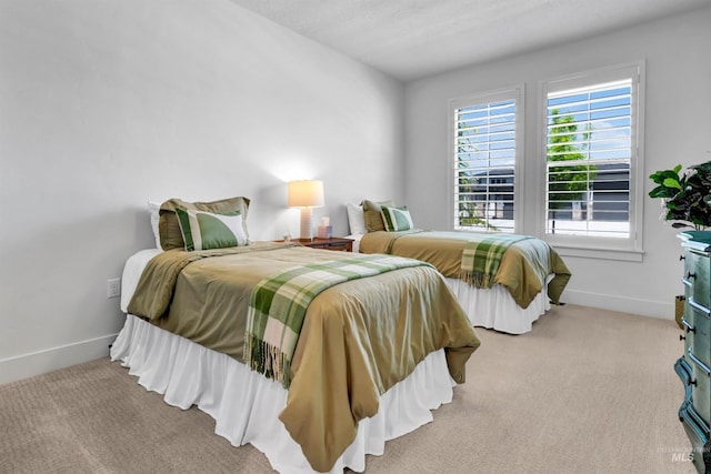 bedroom with baseboards and carpet floors