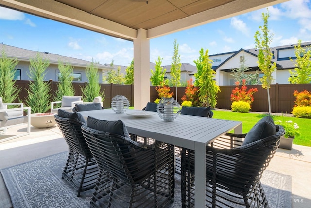 view of patio with a fenced backyard, an outdoor fire pit, and outdoor dining space