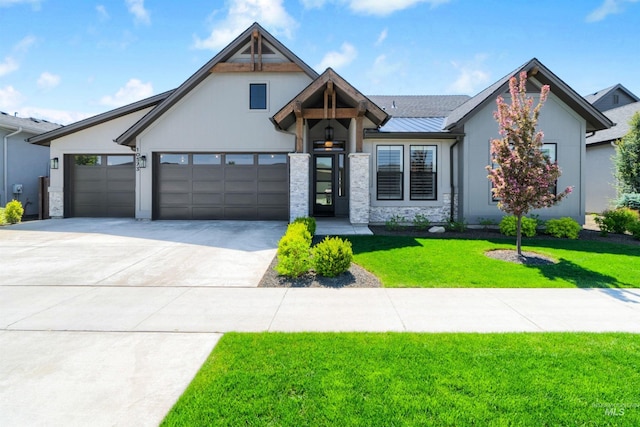 modern farmhouse featuring a front yard, driveway, an attached garage, stone siding, and a standing seam roof
