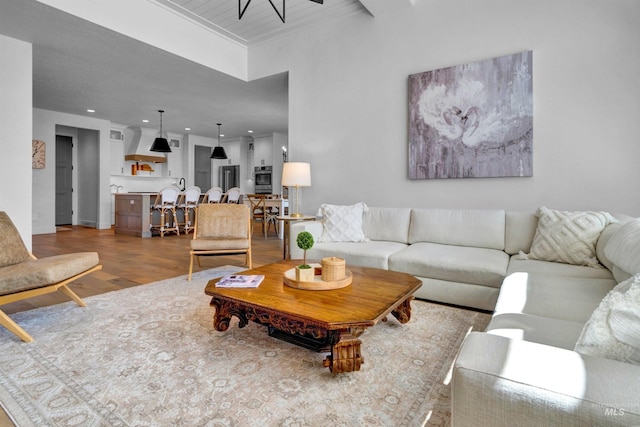 living room with wood finished floors, recessed lighting, and baseboards