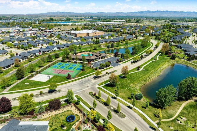 view of property location featuring a water and mountain view and nearby suburban area