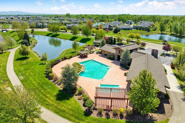 view from above of property with a large body of water and a pool