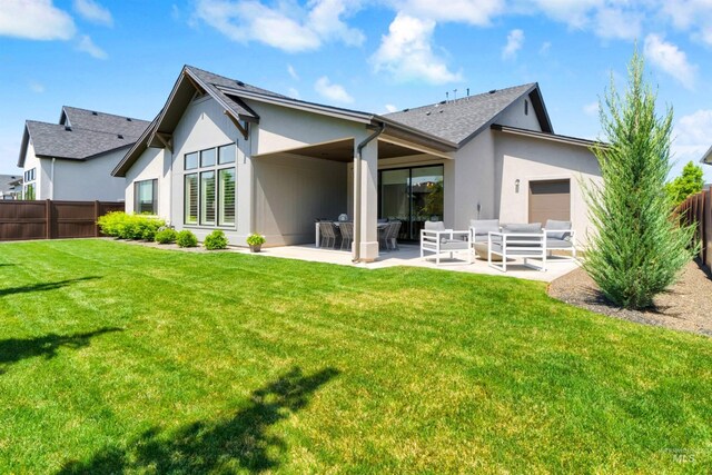 back of property featuring stucco siding, a patio, a shingled roof, and an outdoor hangout area