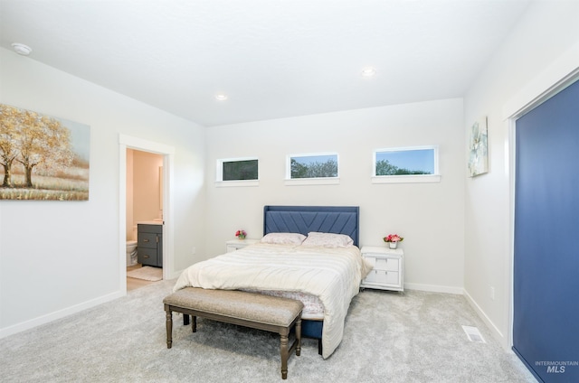 carpeted bedroom with ensuite bathroom